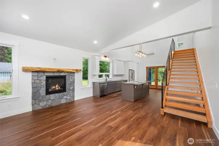 Open floor plan with soaring vaulted ceilings.