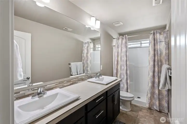 Guest bathroom with large shower.