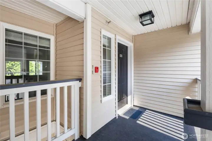 Front Entry: Covered entryway provides a welcoming approach to this top-floor condo, combining convenience and privacy.