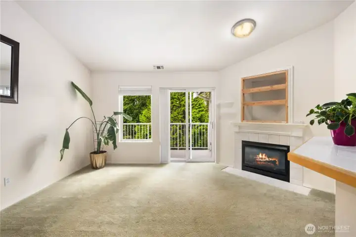 Living Room: Bright living room with vaulted ceilings, cozy gas fireplace, and direct access to private deck overlooking the lush greenbelt. A perfect blend of comfort and tranquility.