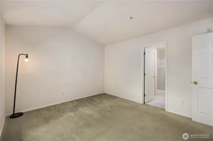 Primary Bedroom: Spacious primary suite with vaulted ceiling, walk-in closet, and ensuite bath. Peaceful retreat with greenbelt outlooks.