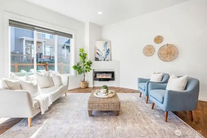 Large living room with large windows and a cozy fireplace