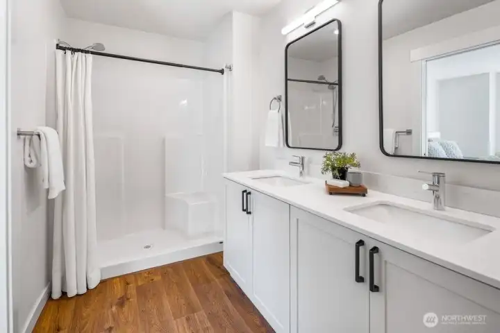 Primary bath. Nice walk-in shower and double sink vanity w/ quartz counters.