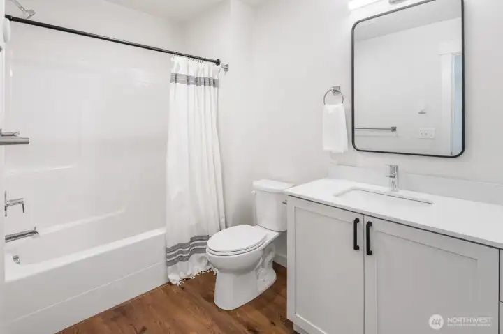 Full bath upstairs next to two bedrooms.