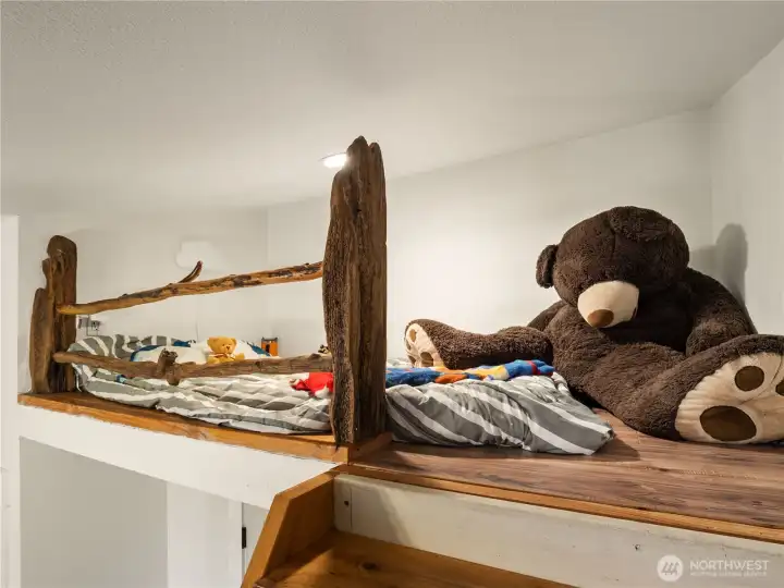 A cozy sleeping loft or tree house makes this room the perfect place to play and cozy up.