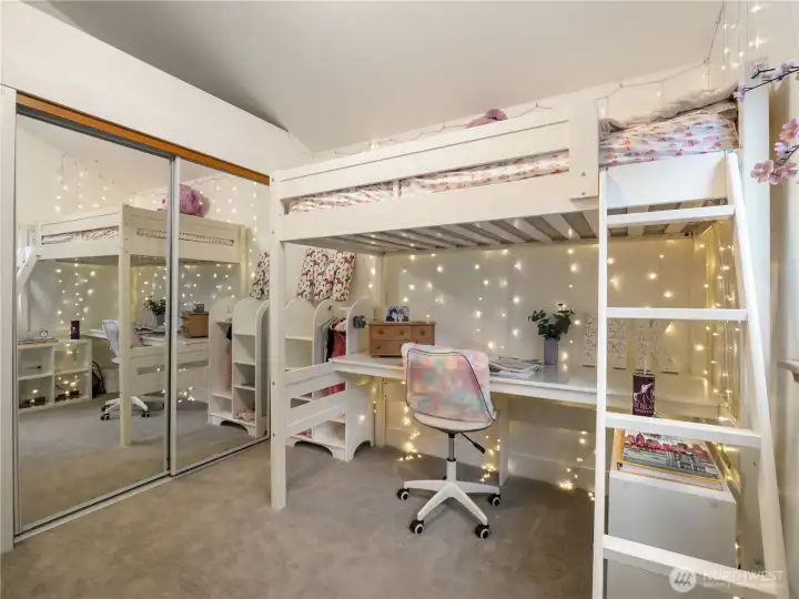 The 3rd bedroom with tall ceilings and mirrored closet doors.