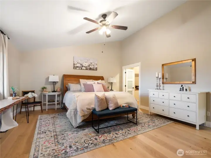 The primary bedroom on the top floor features two walk-in closets, tall ceilings and a primary suite. White oak floors are just a few years old and is in most of the home. Owner is leaving additional flooring for the new home owner to install in bedroom 2 and 3 if so desired.
