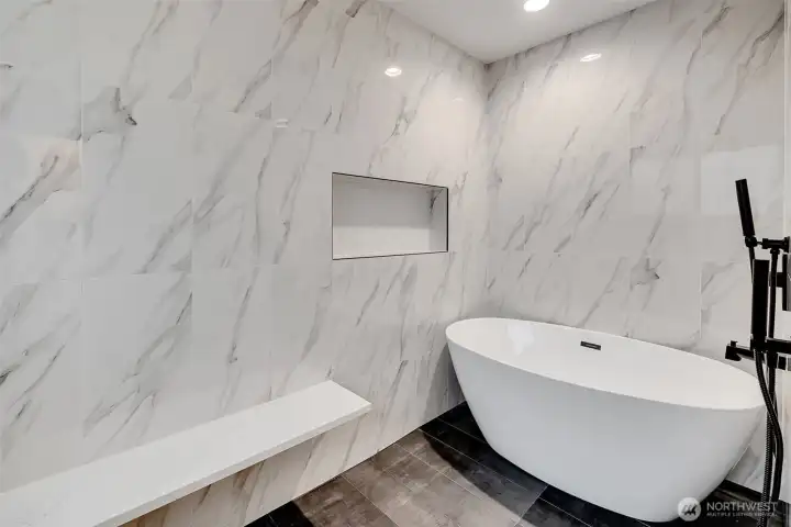 Primary bedroom’s bath with large walk-in shower and tub.