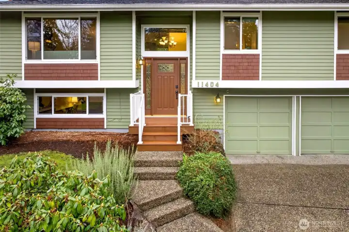 The front entry offers a welcoming landing with clean lines, updated style railings, and a centered, timeless look. It’s an easy, comfortable approach that sets the tone for the home’s practical layout. From here, everything flows naturally, with the garage close by for effortless daily convenience.