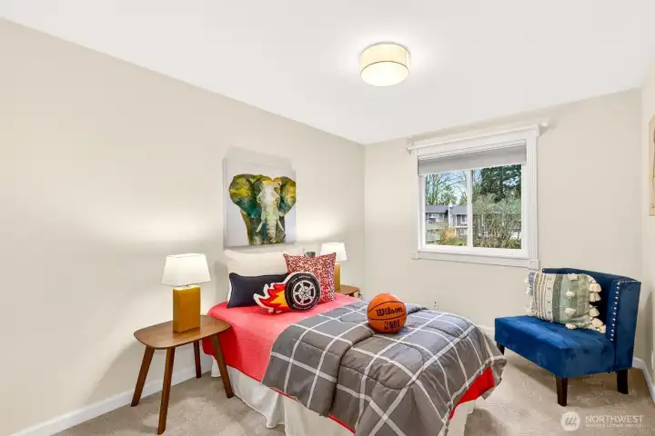 Another inviting bedroom with plush carpet and a large window that keeps the space light and cheerful. The proportions allow for a variety of furniture layouts, from a sleeping space to a dedicated office or creative studio. It’s a versatile room that supports changing needs over time.