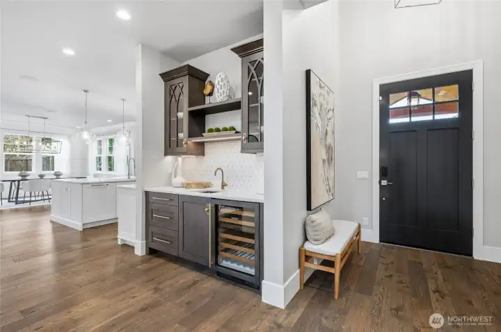 Convenient butler's bar with a beverage fridge and lighting.