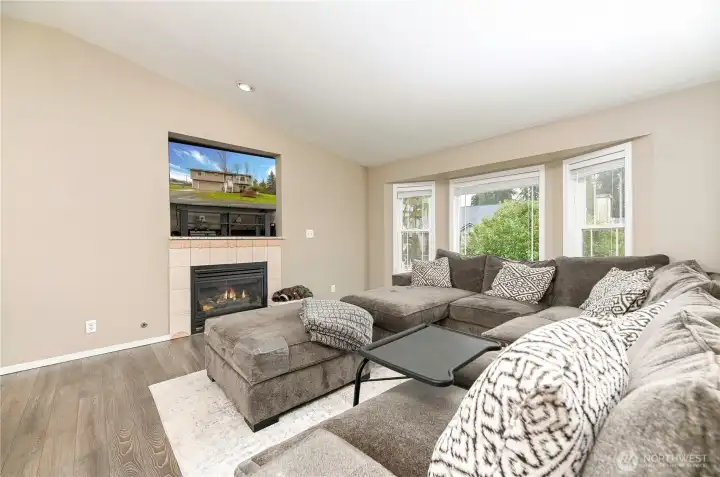 Propane fireplace and large bay window.