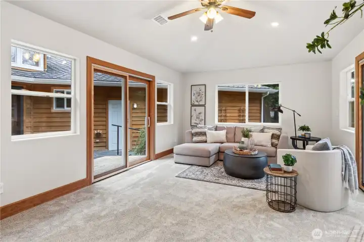 Second living/ game room w/ two sliding glass doors. One to patio and the second to a trex deck overlooking the front yard.