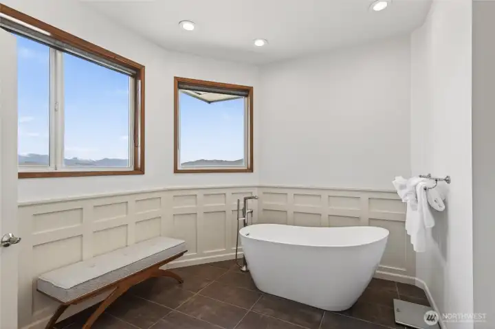 Primary bathroom suite with heated floors and views.
