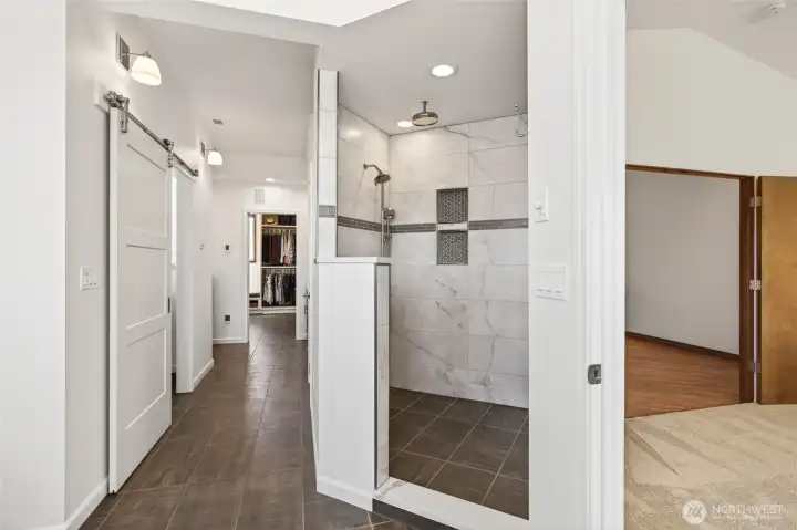 Primary bathroom suite with heated floors and walk-in tile shower.