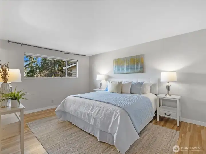 The primary bedroom has hardwood floors. The suite includes a 3/4 bath and walk-in closet.