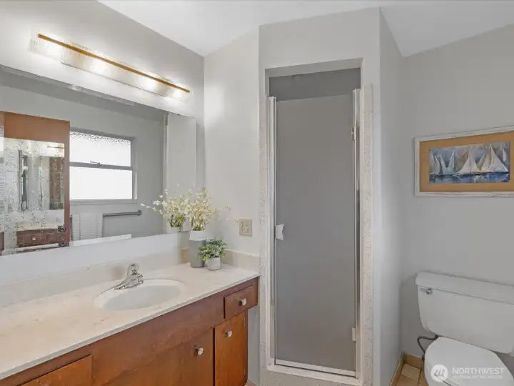 The primary suite bath has a tiled floor and shower.