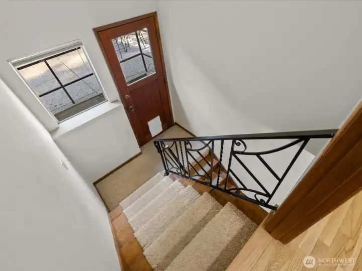 The stairs to the lower level have this convenient landing with door to the backyard.