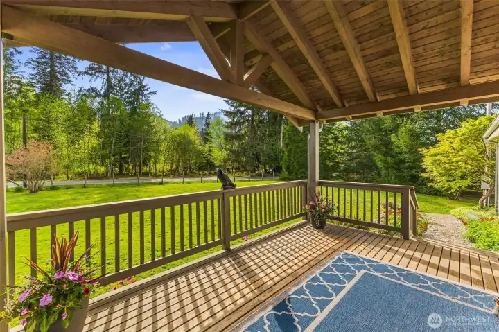 The large covered deck at the front of the home is a perfect place to relax.