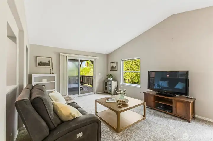 Looking across the spacious family room, to the glass sliding door. That door leads to the second deck and the hot tub. It is a perfect place to BBQ, even in inclement weather, as the deck is covered.