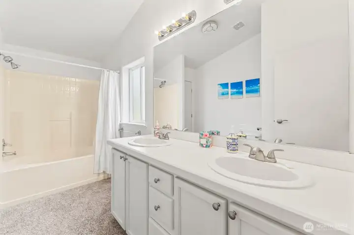 The primary bath offers a large tub/shower combination, a dual sink vanity and a good sized storage closet.