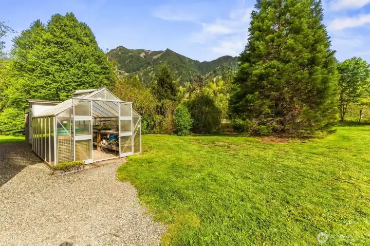 Having a greenhouse on the property elevates the homestead lifestyle, offering a year-round space to nurture plants and grow your own herbs.