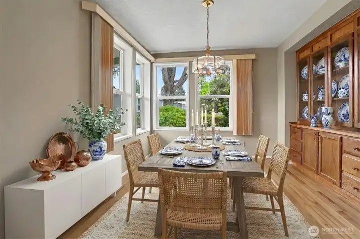 Formal Dining room has laminate floors, built in hutch and overlooks the community greenbelt.  Virtually staged photo.