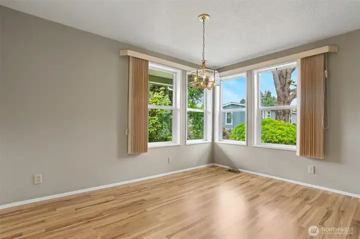 Formal Dining room has laminate floors, built in hutch and overlooks the community greenbelt.