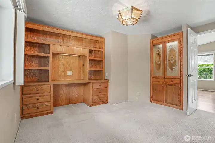 Den/office/bonus room has built in oak cabinets and desk space.  Opens to the formal living room.