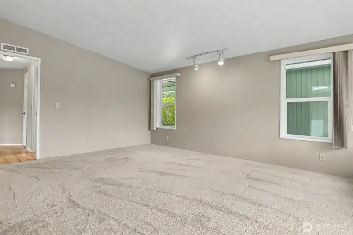 Master bedroom suite with vaulted ceilings, sliding door to light and bright south facing deck and a 3/4 bathroom.