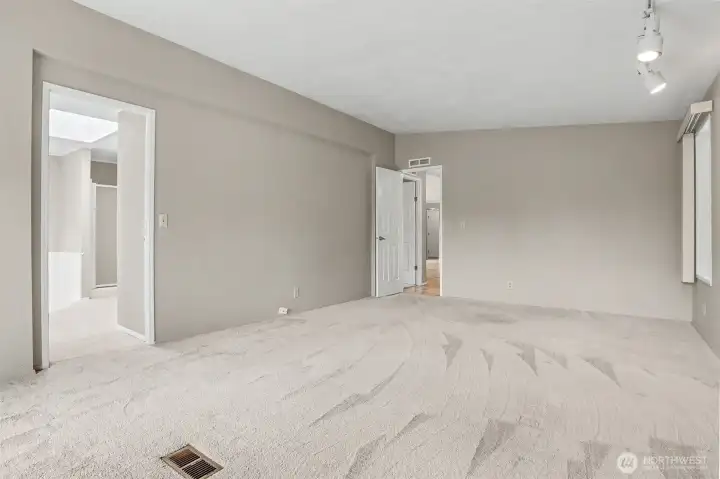 Master bedroom suite with vaulted ceilings, sliding door to light and bright south facing deck and a 3/4 bathroom.