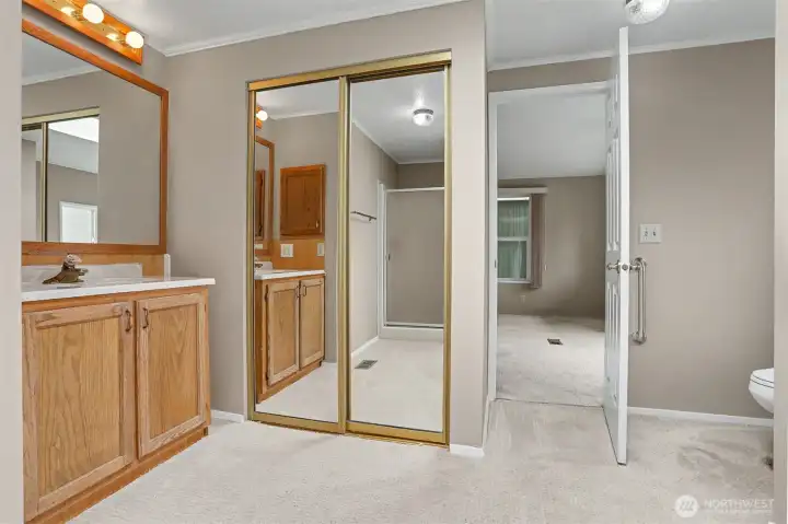Master bedroom suite with vaulted ceilings, sliding door to light and bright south facing deck and a 3/4 bathroom.