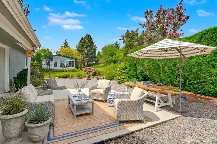 Back patio and courtyard overlooks the community greenbelt that is maintained by the HOA.  Virtually stage photo.