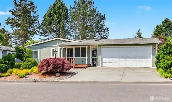 South side view from the street with a detached 2 car garage and off street parking for 2 more cars.