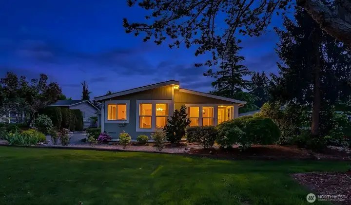 Front (north side) of the home overlooks a community greenbelt.  Virtually staged twilight photo.