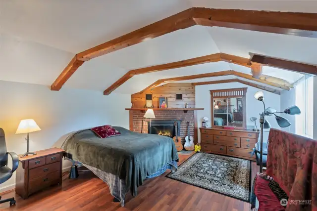 Lower level bedroom with cozy wood fireplace