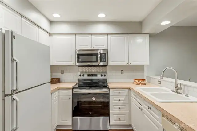 Kitchen w/brand new range/stove. All appliances stay with condo