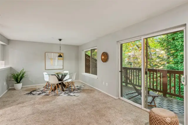 View from living room looking at large dining room great for entertaining. Great backdrop year round from all back windows.