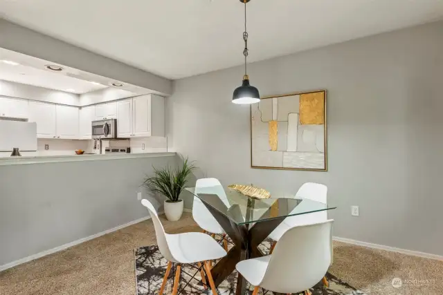 Dining room with kitchen in distance.