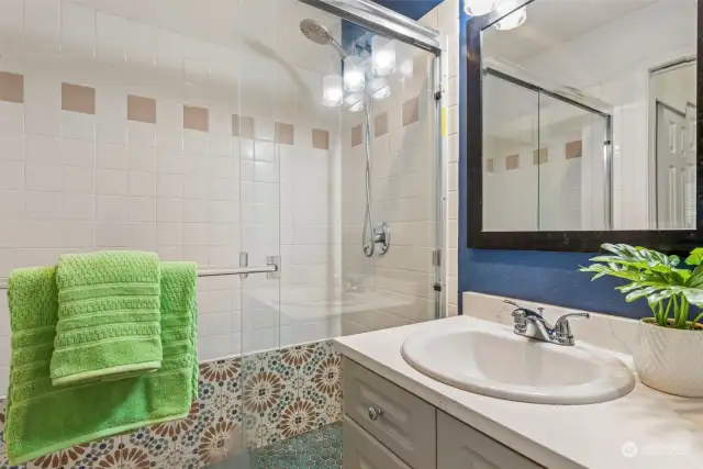 Primary bathroom with newly tiled shower and shower pan.