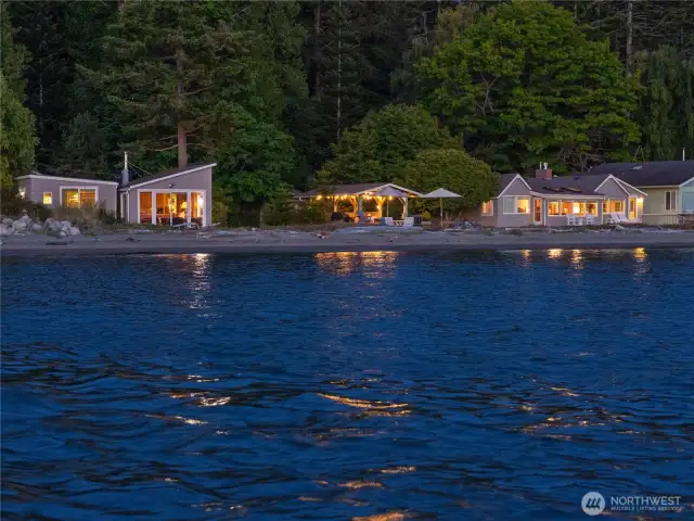 Left to right:  bunk house, cabin, outdoor kitchen cabana, main house.  And the glorious water!