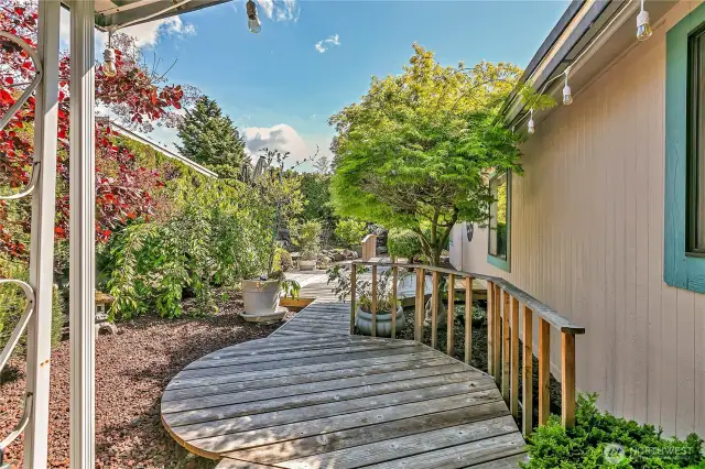 Enjoy serene landscaping, a spacious deck for lounging or dining, and your very own greenhouse for year-round gardening.