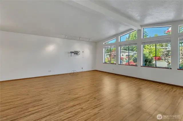 Spacious family room filled with natural light—thanks to large windows that brighten up the space.