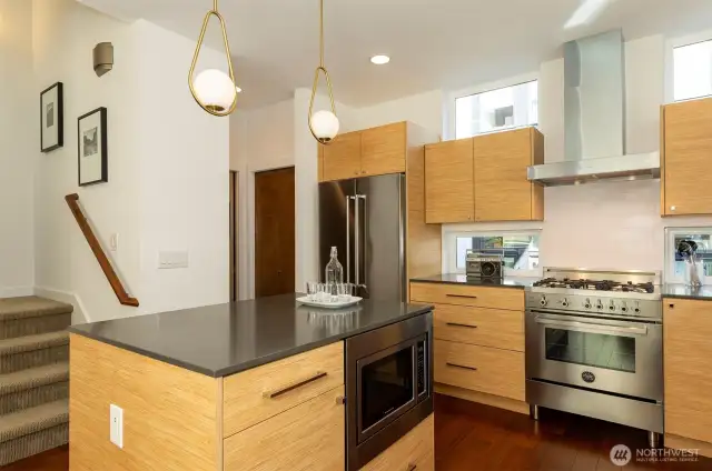 Gas stove, under cabinet microwave and powder room tucked around the corner