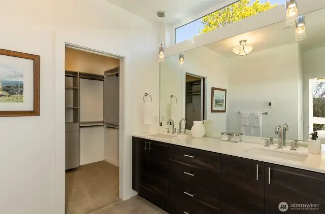 Dual sink vanity and walk-in closet with custom built-ins