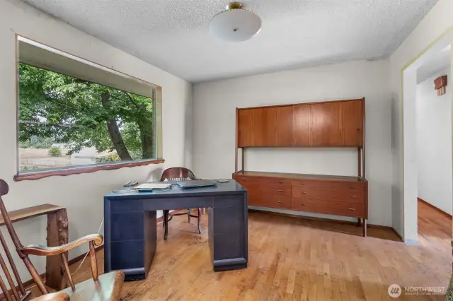 Home office/den. The stunning hardwood floors are ready to be refinished and brought back to life.