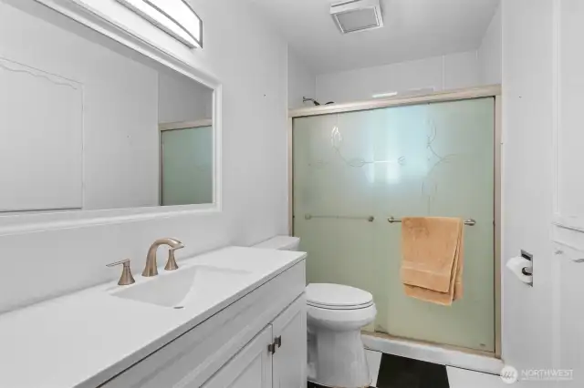 Full guest bathroom with spacious walk-in shower. Matching flooring with the Kitchen.