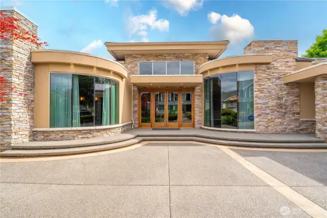 A closer view showcasing this stately home's grandeur with the rounded windows and stone accents.
