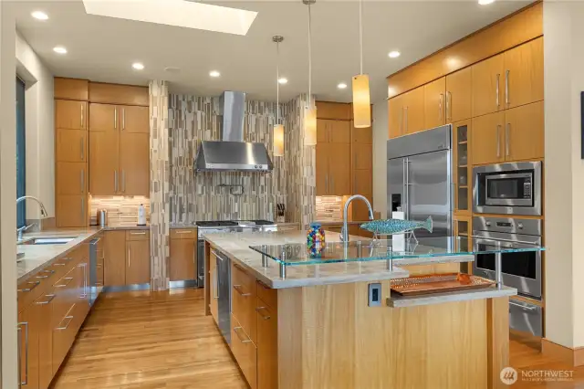 This chef's dream kitchen is designed for both everyday living and grand entertaining, featuring GE Monogram appliances, expansive counters, and custom cabinetry that combines elegance with functionality. Every detail is crafted for style, efficiency, and unforgettable gatherings.