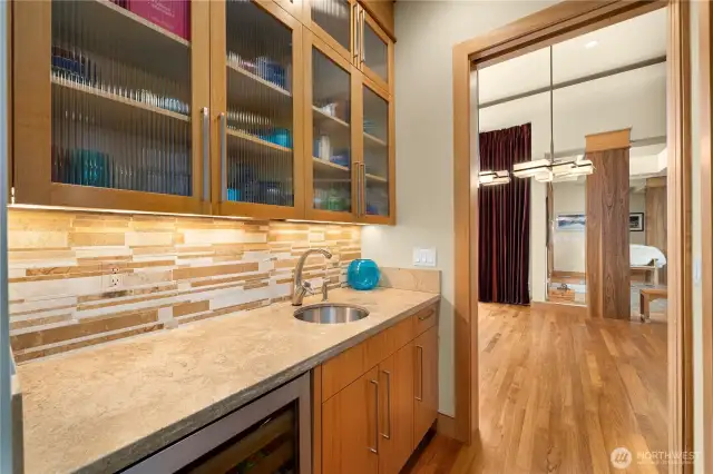 This butler's pantry with a beverage chiller adds more convenience by way of additional storage and seamlessly blends the kitchen and formal dining room.